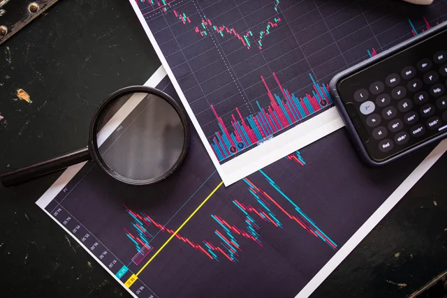 Stock market charts analyzed with a magnifying glass and calculator for financial research. Test four permission states before a privacy first measurement go-live